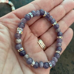 This Angelic Amethyst Iridescent Discs 6mm Energy Bracelet will assist healing your crown chakra energy center that governs your pineal gland, cerebral cortex, frontal lobes, upper brain, central nervous system, and hair. Connects us to the inspiration and our consciousness and spiritual belief system.