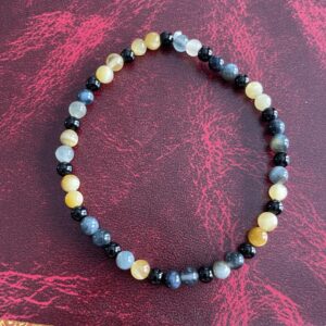 This Yellow & INDIGO Tiger's Eye & Black Agate Bracelet may assist the body with the following healing needs:• Regulating the circulatory system, soothing abdominal pain, and strengthening bones• Aiding in healing broken bones, improving eyesight, and enhancing overall physical strength and endurance• Promoting empowerment, intuition, strategy, and wisdom• Balancing and harmonizing the energies of the Solar Plexus Chakra, enhancing self-worth, personal power, and confidence• Acting as a protective shield and promoting courage and confidence.