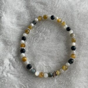 This Yellow & INDIGO Tiger's Eye & Mother of Pearl Bracelet may assist the body with the following healing needs:• Regulating the circulatory system, soothing abdominal pain, and strengthening bones• Aiding in healing broken bones, improving eyesight, and enhancing overall physical strength and endurance• Promoting empowerment, intuition, strategy, and wisdom• Balancing and harmonizing the energies of the Solar Plexus Chakra, enhancing self-worth, personal power, and confidence• Acting as a protective shield and promoting courage and confidence.