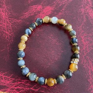This Yellow & INDIGO Tiger's Eye Bracelet may assist the body with the following healing needs:• Regulating the circulatory system, soothing abdominal pain, and strengthening bones• Aiding in healing broken bones, improving eyesight, and enhancing overall physical strength and endurance• Promoting empowerment, intuition, strategy, and wisdom• Balancing and harmonizing the energies of the Solar Plexus Chakra, enhancing self-worth, personal power, and confidence• Acting as a protective shield and promoting courage and confidence.
