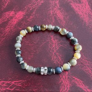This Yellow & INDIGO Tiger's Eye Bracelet may assist the body with the following healing needs:• Regulating the circulatory system, soothing abdominal pain, and strengthening bones• Aiding in healing broken bones, improving eyesight, and enhancing overall physical strength and endurance• Promoting empowerment, intuition, strategy, and wisdom• Balancing and harmonizing the energies of the Solar Plexus Chakra, enhancing self-worth, personal power, and confidence• Acting as a protective shield and promoting courage and confidence.
