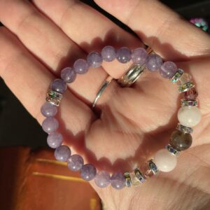 This Angelic Bliss 6mm Energy Bracelet will assist healing your crown chakra energy center that governs your pineal gland, cerebral cortex, frontal lobes, upper brain, central nervous system, and hair. Connects us to the inspiration and our consciousness and spiritual belief system.