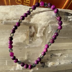 This Sugilite & AB Crystal Accents 4mm Energy Bracelet will assist healing your crown chakra energy center that governs your pineal gland, cerebral cortex, frontal lobes, upper brain, central nervous system, and hair. Connects us to the inspiration and our consciousness and spiritual belief system.